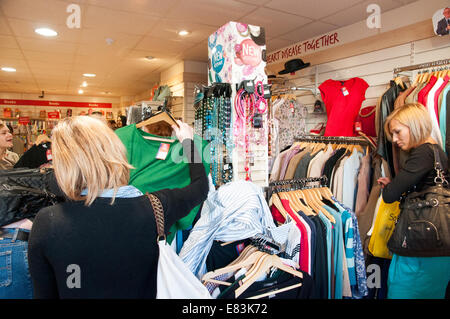 People shopping in Oxfam charity shop, London, England, UK Stock Photo