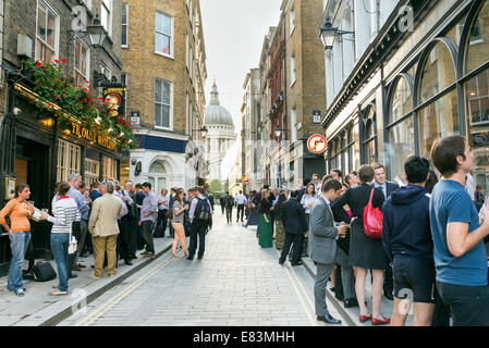 Office workers drinking after work outside pub in Watling Street, City of London, England, UK Stock Photo