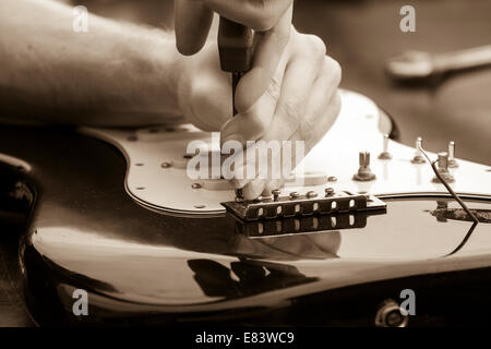 Repairing electric guitar Stock Photo