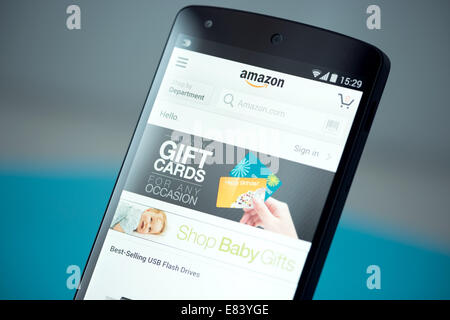 Clouse-up shot of brand new Google Nexus 5, powered by Android 4.4 version, with Amazon website page on a screen. Stock Photo