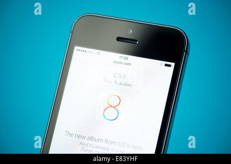 Close-up shot of brand new Apple iPhone 5S showing apple.com website on a screen, featured new iOS8 operation system. Stock Photo