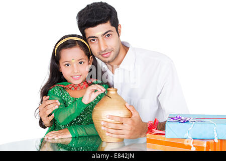 South Indian father saving money with child Stock Photo