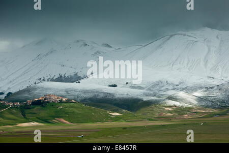 Castelluccio di Norcia and the Piano Grande in late spring, with snowy mountains; Monti Sibillini National Park, Italy. Stock Photo