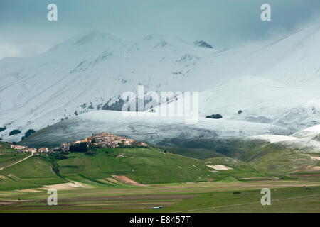 Castelluccio di Norcia and the Piano Grande in late spring, with snowy mountains; Monti Sibillini National Park, Italy. Stock Photo