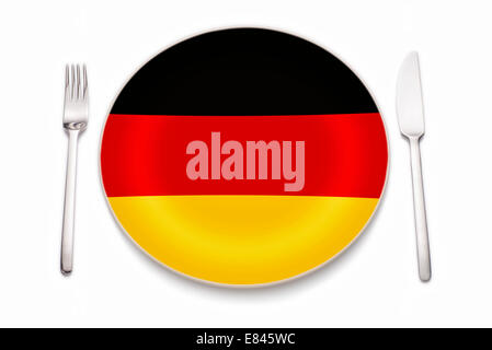 Knife, fork and a plate in the colors of the German flag. Stock Photo