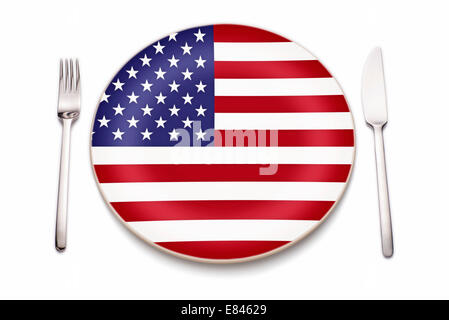 Knife, fork and a plate in the colors of the American flag. Stock Photo