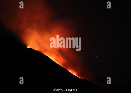 Lava pouring from the summit of Mount Stromboli in the Italian Aeolion Islands. Stock Photo