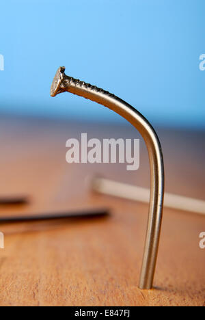 Bent nail in a board Stock Photo