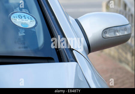 A traditional tax disc is pictured on a car in Chippenham,on Wednesday 1st October 2014 the tax disc will be abolished after being in use for 93 years. Car drivers will still pay the car tax but police cameras will automatically check a car's number plate to establish if this tax has been paid. Stock Photo