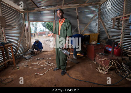 Rwandan welder in his metal and wood workshop, Kigali, Rwanda Stock Photo