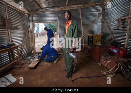 Rwandan welder in his metal and wood workshop, Kigali, Rwanda Stock Photo