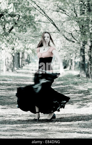 Woman dancing in the park. Stock Photo