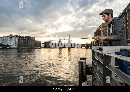 Berlin, Germany, Michael Wickert, founder of embers and shavings, angling on the river Spree