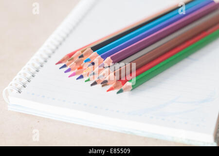 Closeup colorful pencil crayons on spiral notebook, stock photo Stock Photo