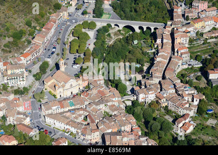 AERIAL VIEW. Medieval village on the riverbanks of the Paillon River. L'Escarène, Alpes-Maritimes, French Riviera's hinterland, France. Stock Photo