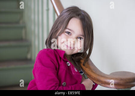 Little girl leaning against bannister, portrait Stock Photo