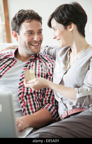 Couple using credit card to shop online Stock Photo