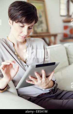 Woman using digital tablet at home Stock Photo