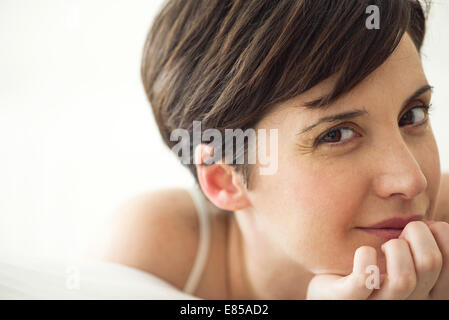Woman relaxing on bed, portrait Stock Photo