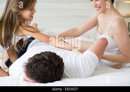 Family playing on bed Stock Photo