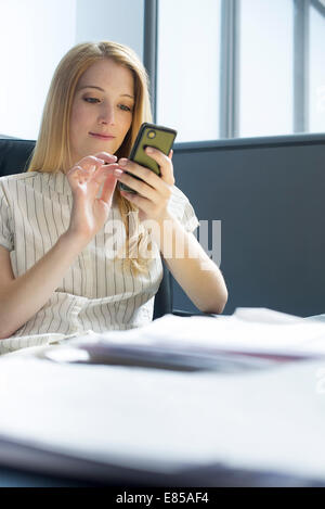 College student using smartphone during study break Stock Photo