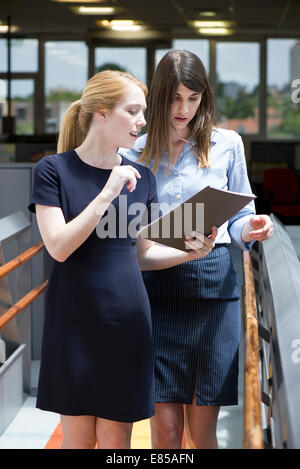 Businesswomen reviewing business document Stock Photo