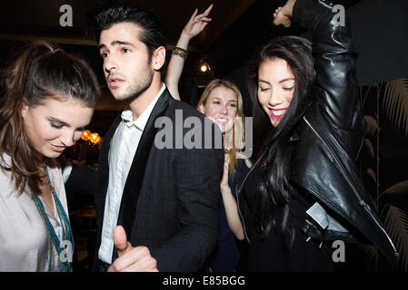 Young adults dancing at night club Stock Photo