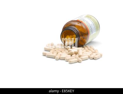 closeup of medical bottle and heap of pills fallen out from Stock Photo