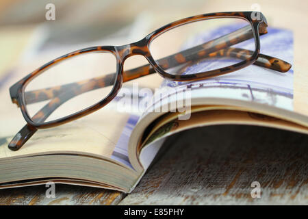Reading glasses on open book Stock Photo