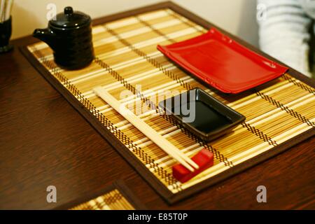 A closeup of a japanese dinner-set: plates and sticks on the table Stock Photo
