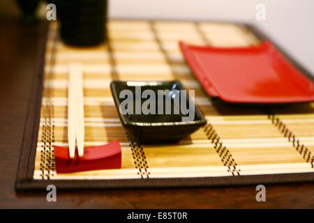 A closeup of a japanese dinner-set: plates and sticks on the table Stock Photo
