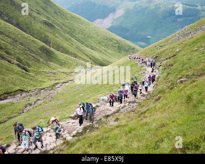 The tourist path up to Ben Nevis crowded with walkers, Scotland UK Stock Photo