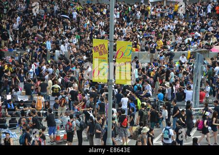 On Wednesday 1st October 2014, banners celebrate the 65th anniversary of the founding of the People's Republic of China, as thousands participate in the fourth day of the pro-democracy protest known as 'Occupy Central', blocking traffic on major roads in downtown Hong Kong. The mood continues to be calm and non-violent, whereas three days earlier, protestors faced tear gas and pepper spray from police in full riot gear. Credit:  Stefan Irvine/Alamy Live News Stock Photo