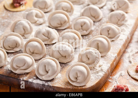 Dumplings. Uncooked on the wooden desk. Stock Photo