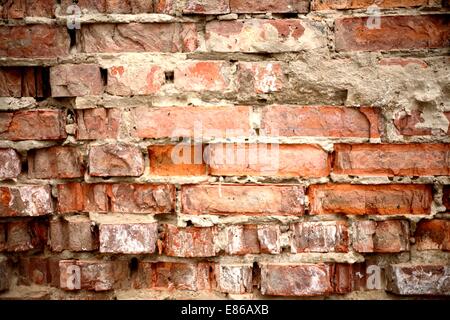 Brick wall background with cement in grungy style. Stock Photo