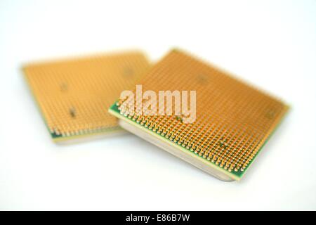 Closeup of a computer processor with golden pins over a white background Stock Photo