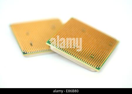 Closeup of a computer processor with golden pins over a white background Stock Photo