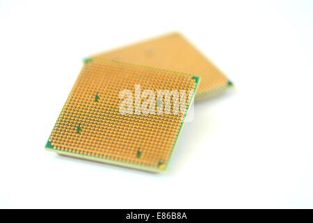 Closeup of a computer processor with golden pins over a white background Stock Photo