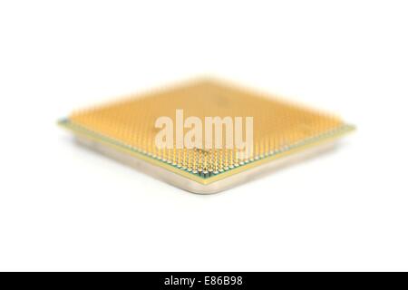 Closeup of a computer processor with golden pins over a white background Stock Photo
