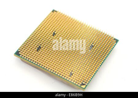 Closeup of a computer processor with golden pins over a white background Stock Photo