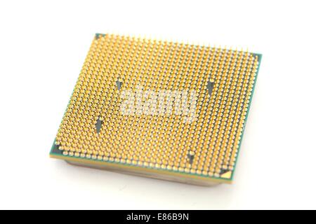 Closeup of a computer processor with golden pins over a white background Stock Photo
