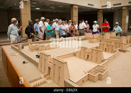 Egypt, Luxor, Karnak Temple Visitor Centre, tourists on Swan Hellenic cruise ship guided tour looking at temple complex model Stock Photo