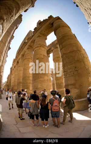 Egypt, Luxor, Karnak Temple, tourists amongst columns of Great Hypostyle Hall, fish eye wide angle distortion Stock Photo
