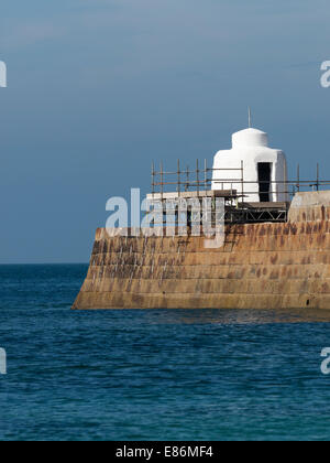 Portreath pier stone 'monkey house' hut being repaired after the after the winter 2013/14 storm waves damage Cornwall England Stock Photo