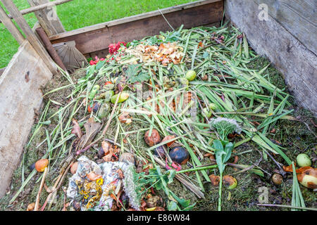 Garden compost heap in wooden composter, composting waste Stock Photo