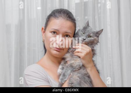 women with a cat indoors Stock Photo