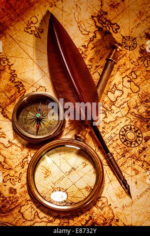 Vintage map and vintage compass with magnifying glass at the corner ...