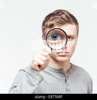 Man looking through a magnifying glass Stock Photo