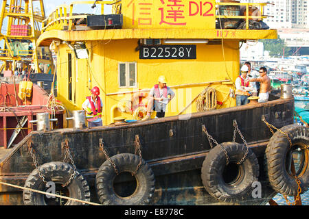 Team Of Engineers On The Deck Of A Derrick Barge In The Causeway Bay Typhoon Shelter, Hong Kong. Stock Photo