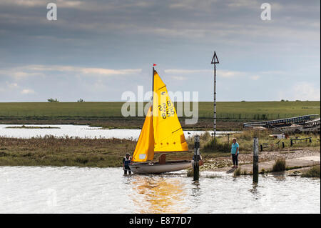 A small sailboat being launched on the Blackwater River in Essex. Stock Photo